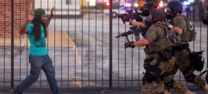 The Ferguson police department riot squad moving towards a protester. (photo: Getty Images)