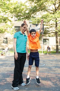 Zaida Ramos, employed at Cooperative Home Care Associates, with her son in their East Harlem, N.Y., neighborhood. YES! photo by Stephanie Keith.