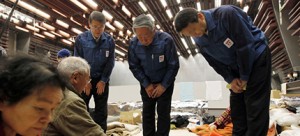 TEPCO executives bow their heads to apologize to evacuees at a shelter in Koriyama. Will any face criminal prosecution? (photo: Ken Shimizu/AFP/Getty Images)