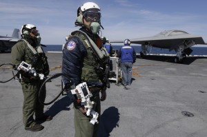 Northrop Grumman test pilots prepare to taxi the Navy X-47B drone, to be launched off the USS George H. W. Bush. (Credit: AP/Steve Helber)