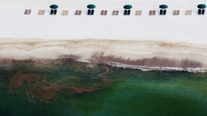 Photographer: Kari Goodnough/Bloomberg Empty beach chairs rest on the sand as oil washes ashore in Orange Beach, Alabama, on June 19, 2010.