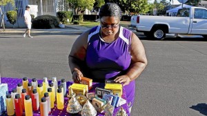 Jackie Lloyd sells body oils, shea butter, soap and incense after having been laid off from her job as an elementary school cafeteria worker four years ago. (Anne Cusack / Los Angeles Times)