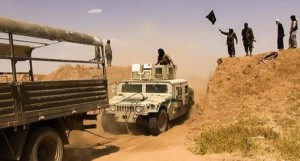 Islamic State of Iraq and the Levant militants waving the trademark Jihadist flag on the Syrian-Iraqi border  Credit: Agencé France-Presse