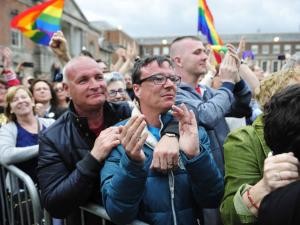 People celebrate as the final vote of the referendum on same-sex marriage is announced, in Dublin Castle, Ireland.  Credit: Aidan Crawley