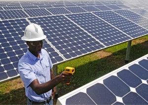 In this Wednesday, May 13, 2015 photo, Henry Plange, a power generation engineer, checks temperatures of solar panels at the Space Coast Next Generation Solar Center, in Merritt Island, Fla. Industry experts rank Florida third in the nation in rooftop solar energy potential but 13th in the amount of solar energy generated.  Credit: AP Photo/John Raoux