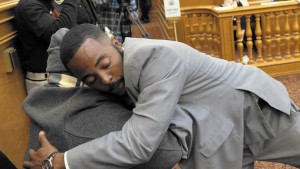 Will Hambrick hugs Robert Harris after giving his public comment at the San Francisco Police Commission meeting. The fate of several police officers involved in racist and homophobic text messaging was under consideration.  Credit: Carlos Avila Gonzalez, San Francisco Chronicle