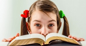 girl looking over a Bible