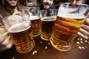 Four men toasting with fresh beer