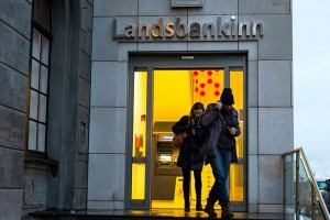 Customers at a Landsbankinn branch in Reykjavik, Iceland. The bank was established by the government during the 2008 crisis.  Credit: Richard Perry/The New York Times