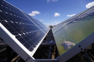 In this Feb. 26, 2015 photo, solar panels that are part of the Wright-Hennepin Cooperative Electric Association's community gardens are shown in Rockford, Minn. Community solar gardens are a new concept in renewable energy, allowing customers who cannot put up solar panels to buy into the green energy boom anyway. Credit: AP Photo/Jim Mone