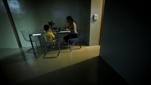 A women sits with her son for dinner in their new sparsely furnished apartment, Thursday, Aug. 13, 2015, in New York. After leaving her husband who beat her for years, she and her little boy spent the next three years homeless because she couldn’t afford New York City rents. About one third of American children are now living in poverty.  Credit: AP Photo/Bebeto Matthews