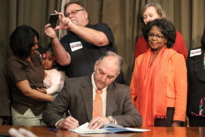 Louisiana Democratic Governor John Bel Edwards signing executive order expanding Medicaid Credit: Kevin Litten/Times Picyune