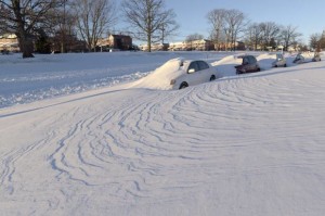 Wind-blown snow buries vehicles, Sunday, Jan. 24, 2016, in Parkville, Md. Millions of Americans were preparing to dig themselves out Sunday after a mammoth blizzard with hurricane-force winds and record-setting snowfall brought much of the East Coast to an icy standstill. Credit: AP/Steve Ruark