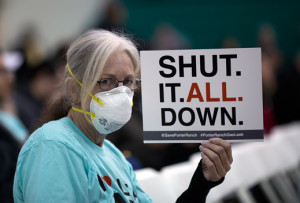 A woman holds a sign while attending a public hearing on January 16 regarding the massive natural-gas leak near Porter Ranch, California.