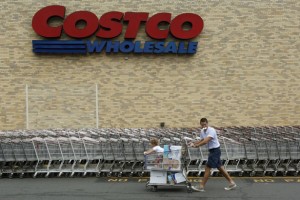 A shopper wheels his cart from a Costco  Credit: Reuters/Richard Clement 