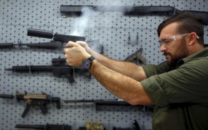 SilencerCo CEO Joshua Waldron fires a handgun with a suppressor in West Valley City, Utah February 23, 2016. Gun silencers or suppressors, the accessory of Hollywood hit men, are becoming increasingly popular in the real world as hunters and other gun owners adopt them for hearing protection. Credit: Reuters/Jim Urquhart