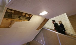 American Federation of Teachers representatives walk by some missing ceiling tiles while touring Osborn high school in Detroit in January. Credit: Romain Blanquart/Zumapress.com 