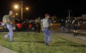 Heavily armed civilians with a group known as the Oath Keepers arrive in Ferguson, Missouri, on Aug. 11, 2015. The far-right anti-government activists, largely consists of past and present members of the military, first responders and police officers. Credit: Jeff Roberson/AP 