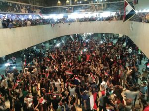 Followers of Iraq's Shiite cleric Moqtada al-Sadr gather in the parliament building as they storm Baghdad's Green Zone after lawmakers failed to convene for a vote on overhauling the government on April 30. Credit: AHMED SAAD / Reuters