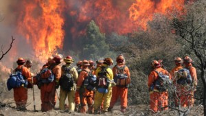 Prisoner fire fighters survey a fire before going to work. Today 30% or California's fire fighters are essentially slave labor