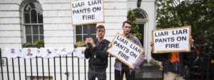 London on 1 July. Demonstrators hold placards with the words "Liar Liar Pants On Fire" written on them as they protest next to underwear, featuring various politicians faces, hung up outside the home of former London Mayor Boris Johnson  Credit: Jack Taylor