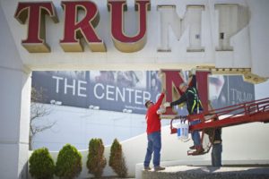 im Williams, of Calvi Electric, lowers the 'M' letter from the signage of Trump Plaza Casino to his co-workers Tony Demidio and Steven Nordaby in Atlantic City, New Jersey October 6, 2014. Credit: Mark Makela/Reuters