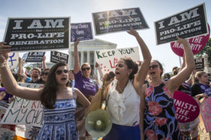 Reagan Barklage of St. Louis, center, and other anti-abortion activists demonstrate in front of the Supreme Court in Washington, Monday, June 27, 2016, as the justices struck down the strict Texas anti-abortion restriction law known as HB2. The justices voted 5-3 in favor of Texas clinics that had argued the regulations were a thinly veiled attempt to make it harder for women to get an abortion in the nation's second-most populous state. Credit: AP /J. Scott Applewhite