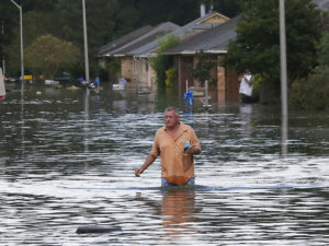 A man wades through a flooded street in Ascension Parish, Louisiana, on August 15, 2016.   Credit: Reuters/Jonathan Bachman