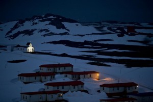 In this Jan. 20, 2015 photo, a church is lit in the town of Villa Las Estrellas on King George Island, Antarctica. Geologists are entranced by Antarctica’s secrets. Clues to answering humanity’s most basic questions are locked in this continental freezer the size of the United States and half of Canada: Where did we come from? Are we alone in the universe? What’s the fate of our warming planet?  Credit: AP Photo/Natacha Pisarenko) 