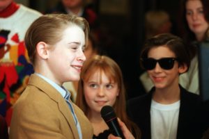 Actor Macaulay Culkin, left, speaks to the media before the premiere of "Richie Rich" at the Mann's Bruin Theater in Los Angeles, Ca., Saturday, Dec. 17, 1994.  Looking on are co-stars Stephi Lineburg, center, and Michael Maccarone.   Credit: Chris Pizzello/AP